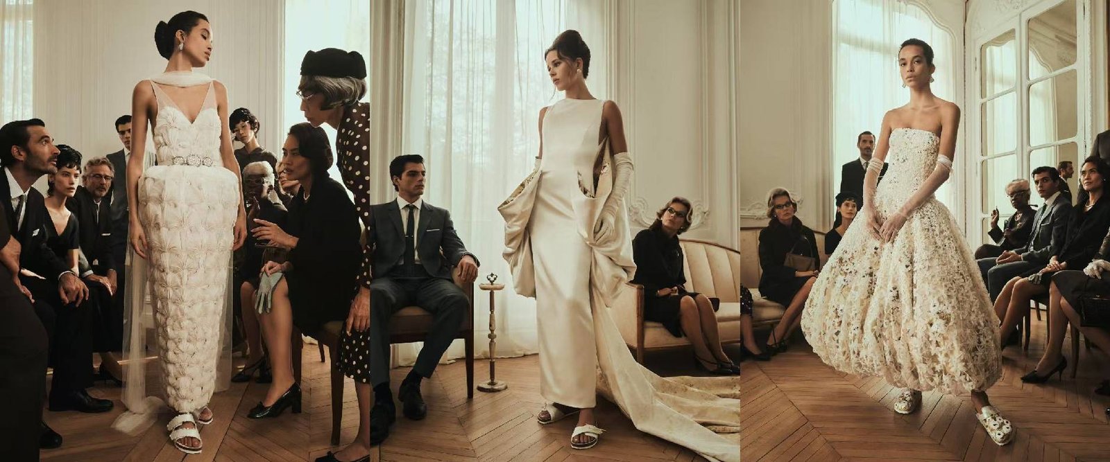 Three elegant white custom wedding dresses displayed on models during a high-fashion bridal presentation with audience